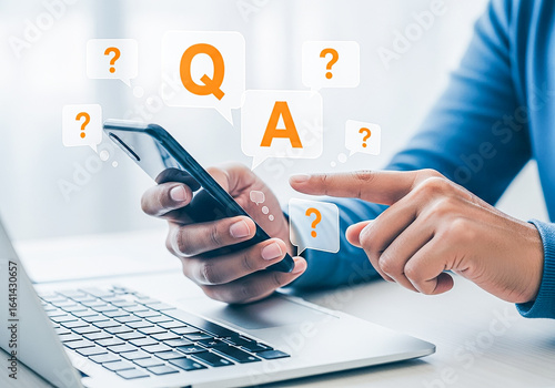 Person using smartphone and laptop with q and a graphics