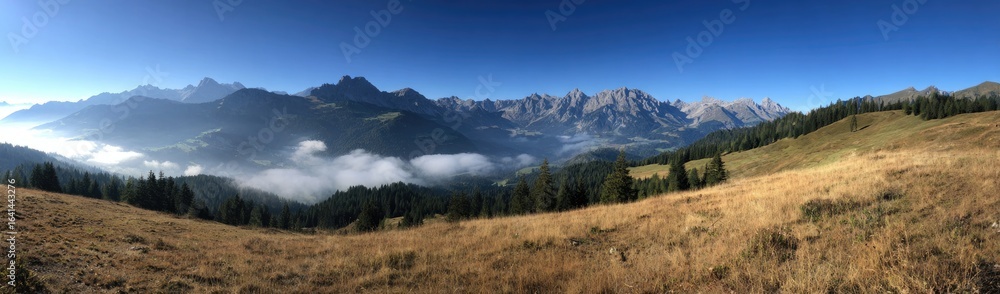 Fototapeta premium Panoramic mountain vista with low clouds
