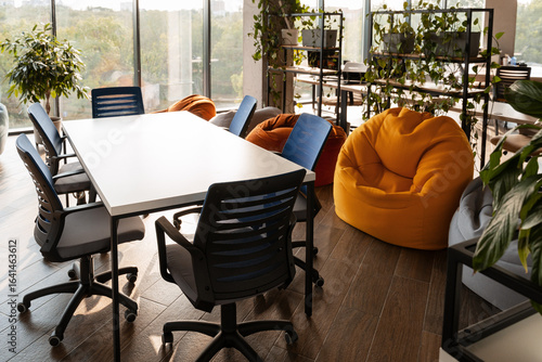Fotografie Modern coworking space with beanbag chairs and meeting table