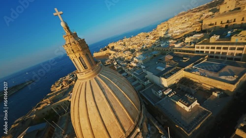 FPV drone view of Valletta, capital of Malta. Main church and dome, sunset city