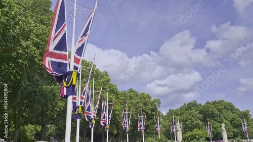 Pan down view a row of Union Jack British flags.