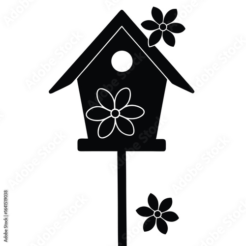 Black silhouette of a decorative birdhouse with flowers