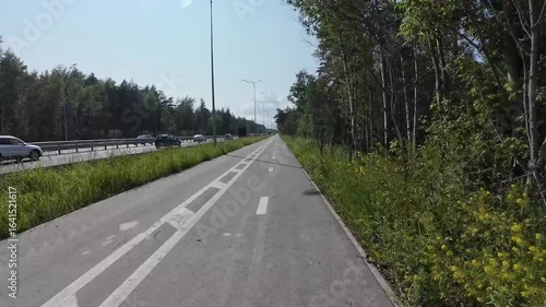 cycling on a bike path outside the city, first-person view, timelapse