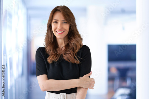 Confident mid aged woman standing in the office Free Download Confident mid aged woman standing in the office - GFXLoad