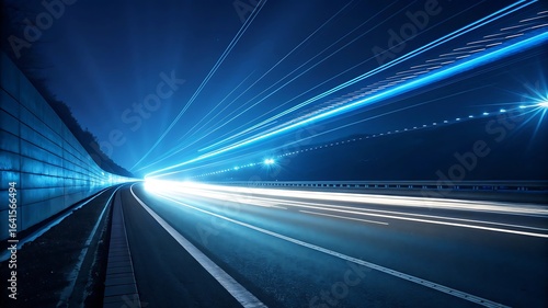 Blue light trails on highway at night tunnel