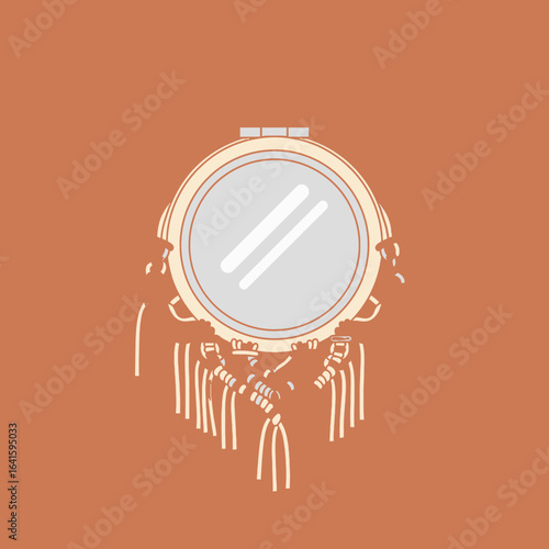 Dreamcatcher with tassels and beads hanging below a circular frame and reflective center.