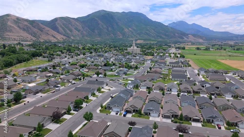 Aerial footage beautifully captures a tranquil residential community in Salt Lake City that is nestled among majestic mountains, stunning and visually appealing landscape that is pleasing to the eye