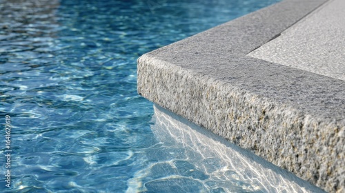 Sunlight reflecting on rippling pool water, illuminating sleek granite coping with luminous, serene ambiance of high end outdoor design