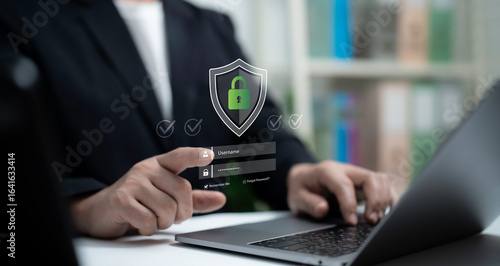 Wallpaper Mural Businessman using laptop with virtual secure login interface and green padlock shield icon, cybersecurity, data protection, privacy, authentication and online account security concept Torontodigital.ca