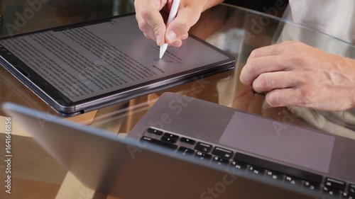 Stylus macro on tablet. painting Electronic Signature on Tablet Computer by Stylus in Male Hand. Sign Document of Deal on PC at Work in Office Indoors. Write Business Agreement for