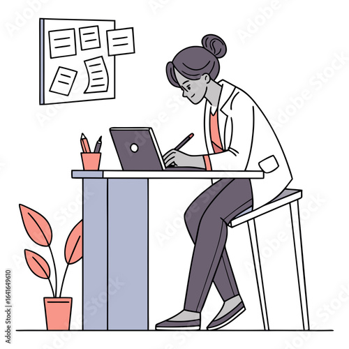 Focused woman in lab coat working on laptop at desk with plant and bulletin board in office
