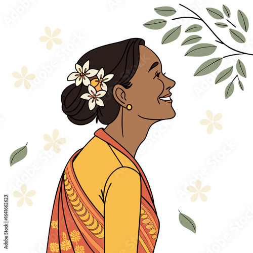 A smiling woman with dark hair adorned with flowers looks up towards a leafy branch and scattered blossoms