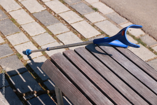 Wallpaper Mural A blue and silver cane is leaning against a wooden bench Torontodigital.ca