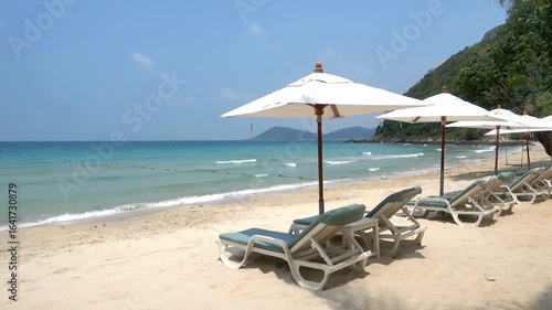 Beautiful beach with umbrellas and sunbeds for relaxing on a sunny day