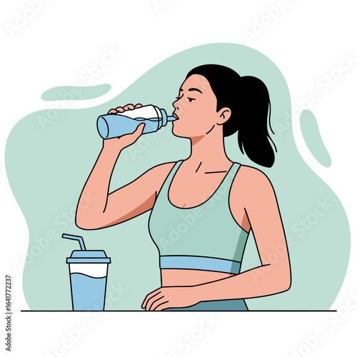 Young woman drinking water from bottle while exercising indoors  