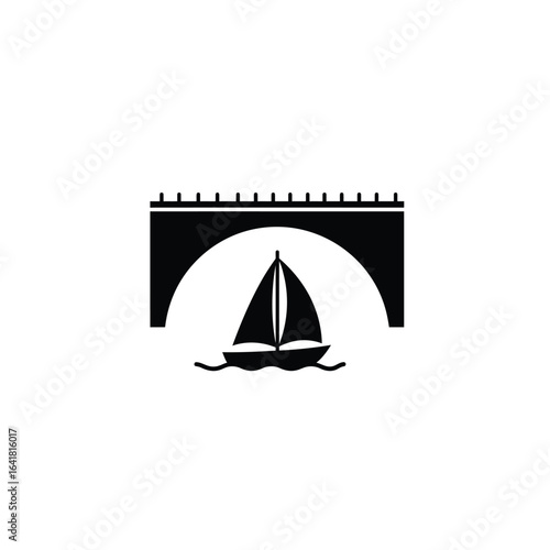 Black sailboat passes under arched bridge white