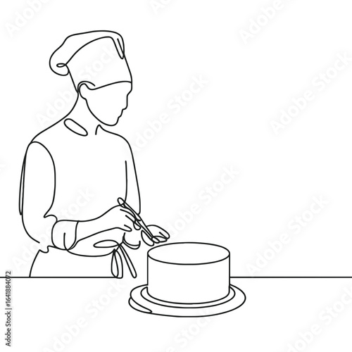 Chef decorating cake on table