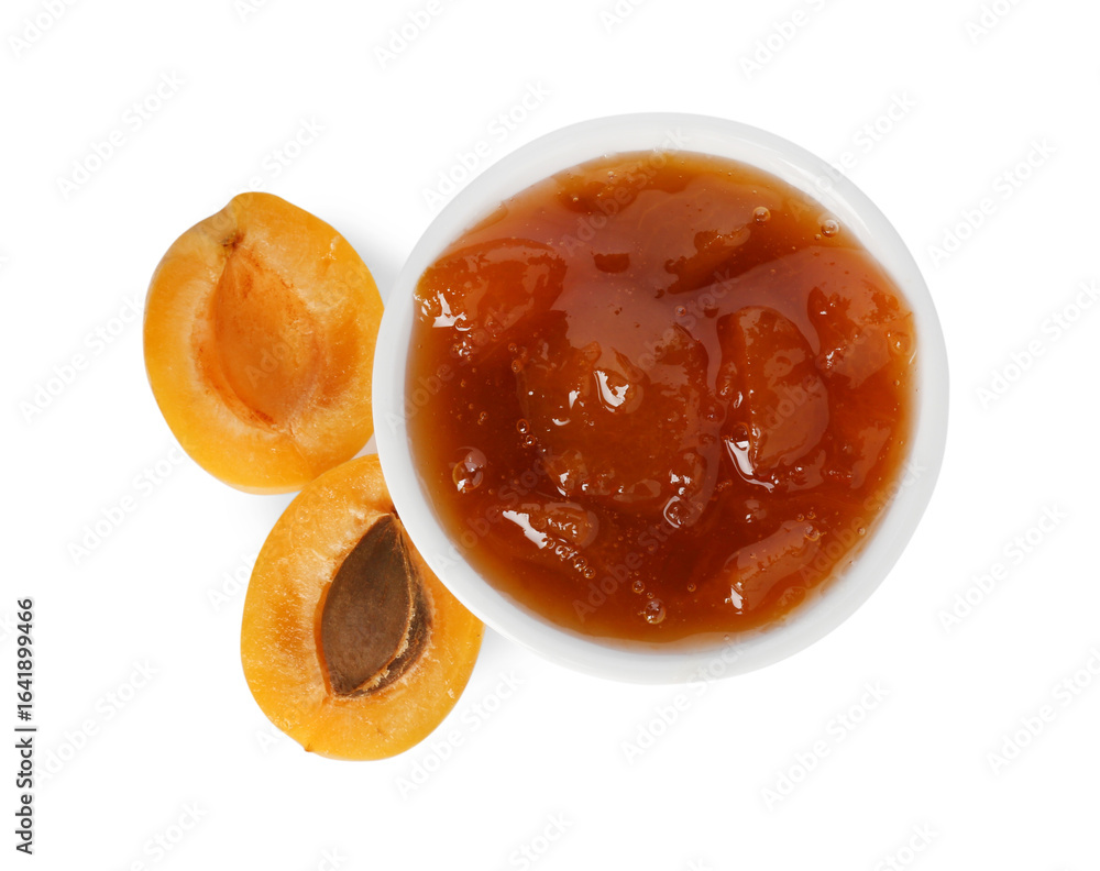 Fototapeta premium Tasty apricot jam in bowl and fresh fruit isolated on white, top view