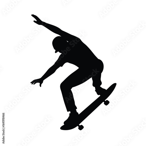 Silhouette of a skateboarder doing a trick