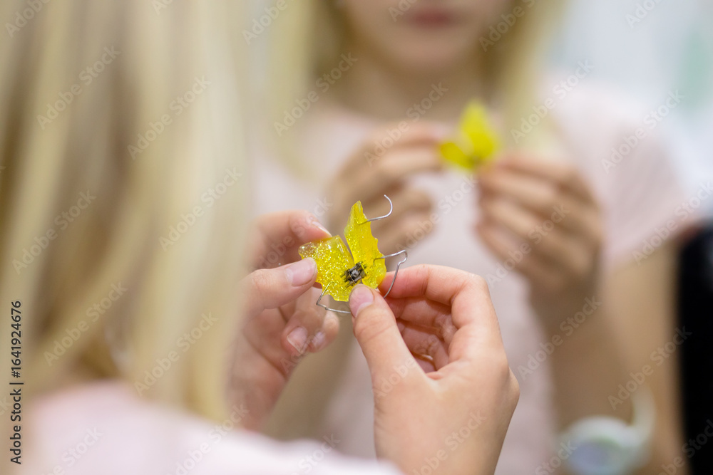 Orthodontic plastic plate in child's hands Orthodontic plastic plate in child's hands