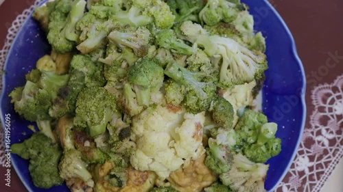 Broccoli and cauliflower are marinated and steamed