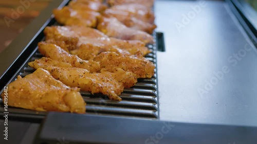 cooking chicken fillet on an electric grill at home