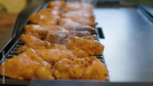 cooking chicken fillet on an electric grill at home