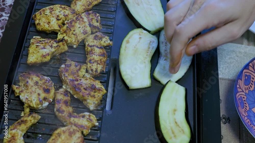 cooking chicken fillet with vegetables on an electric grill at home