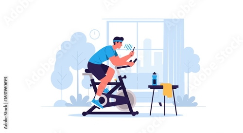 Man riding stationary bicycle indoors watching phone and listening to music for fitness and health