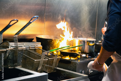 Chef cooks over big Open flames 