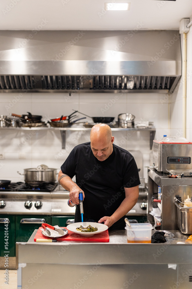 a chef preparing a sea bass dish a chef preparing a sea bass dish