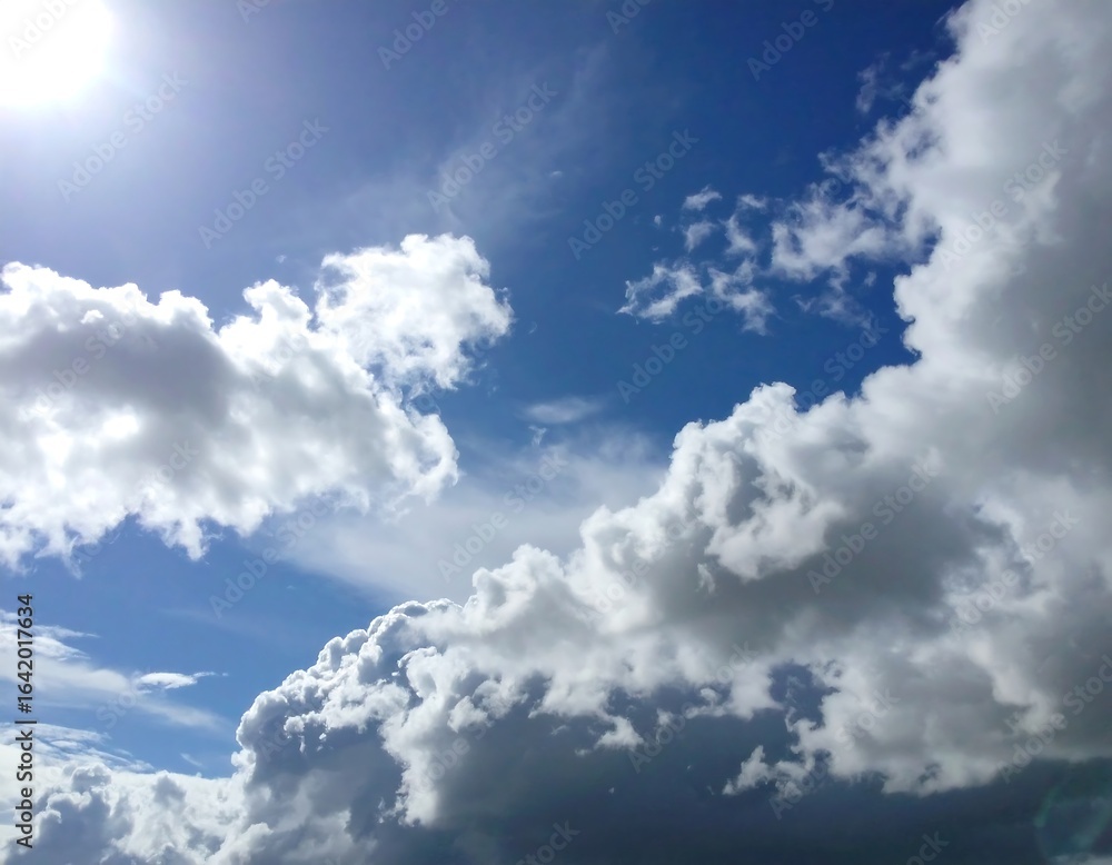 Obraz premium A bright blue sky with puffy white clouds