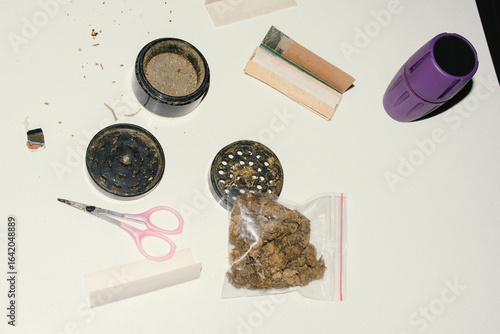 marijuana buds in bag and rolling tools