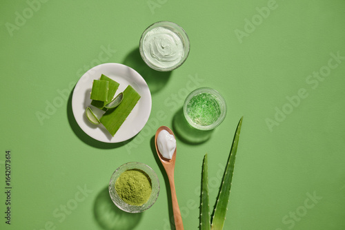 Aloe vera products: fresh leaves, gel, and creams arranged on a