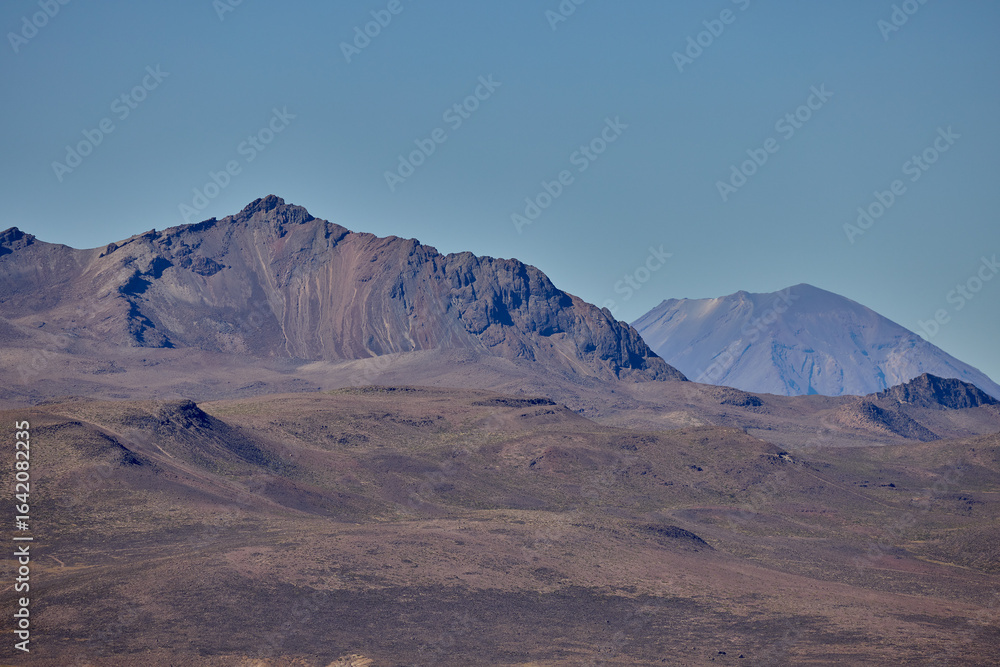 Naklejka premium The east face of Misti Volcano rises above the Arequipa landscape, its graceful cone and rugged slopes bathed in the clear light of the Andes