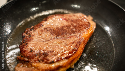 Juicy rare beef steak with perfect sear and appetizing pink center. Succulent meat showcase for gourmet photography, butchers, and premium restaurant marketing