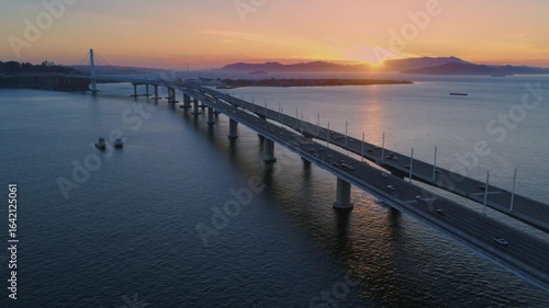 Wallpaper Mural Aerial view of the San Francisco-Oakland Bay Bridge at sunset, with cars commuting. The bridge connects San Francisco and Oakland, California, USA. Torontodigital.ca