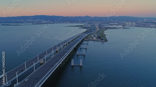 Wallpaper Mural Aerial view of the San Francisco-Oakland Bay Bridge at sunset, with cars commuting. The bridge connects San Francisco and Oakland, California, USA. Torontodigital.ca