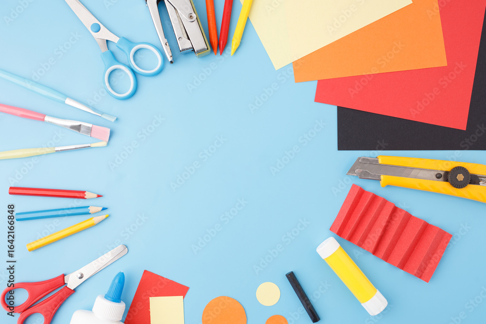 Craft supplies on blue table ready for use in school projects, DIY tutorials, educational content, kids workshops, or stationery branding visuals for e-commerce and marketing Craft supplies on blue table ready for use in school projects, DIY tutorials, educational content, kids workshops, or stationery branding visuals for e-commerce and marketing