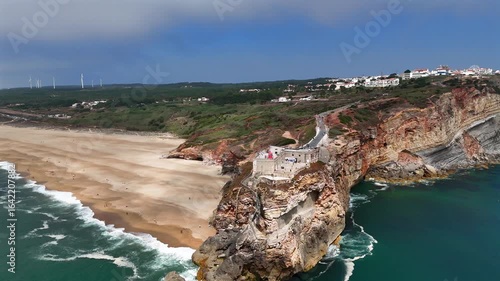Nazaré, Portugal. View from above of the lighthouse on a rock near the Atlantic Ocean.
The rocky coast of Nazaré, a popular surf destination due to its waves.