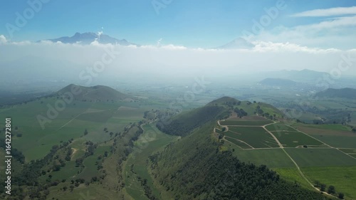 Aerial view of the Popocatépetl volcano in Mexico, seen from beautiful meadows. Mountains and volcanoes of Mexico, travel and vacation concept, 4k nature.
