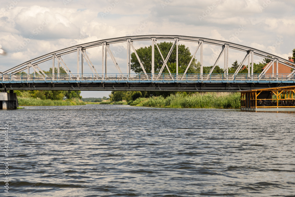 Naklejka premium A bridge spans a river, with a view of the water below
