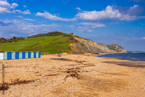 Charmouth Beach huts after a storm washes up flotsam and jetsam