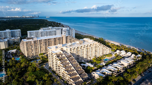  Aerial View of Oceanfront Condominiums in Key Biscayne, Miami, Florida with Blue Atlantic Coastline”