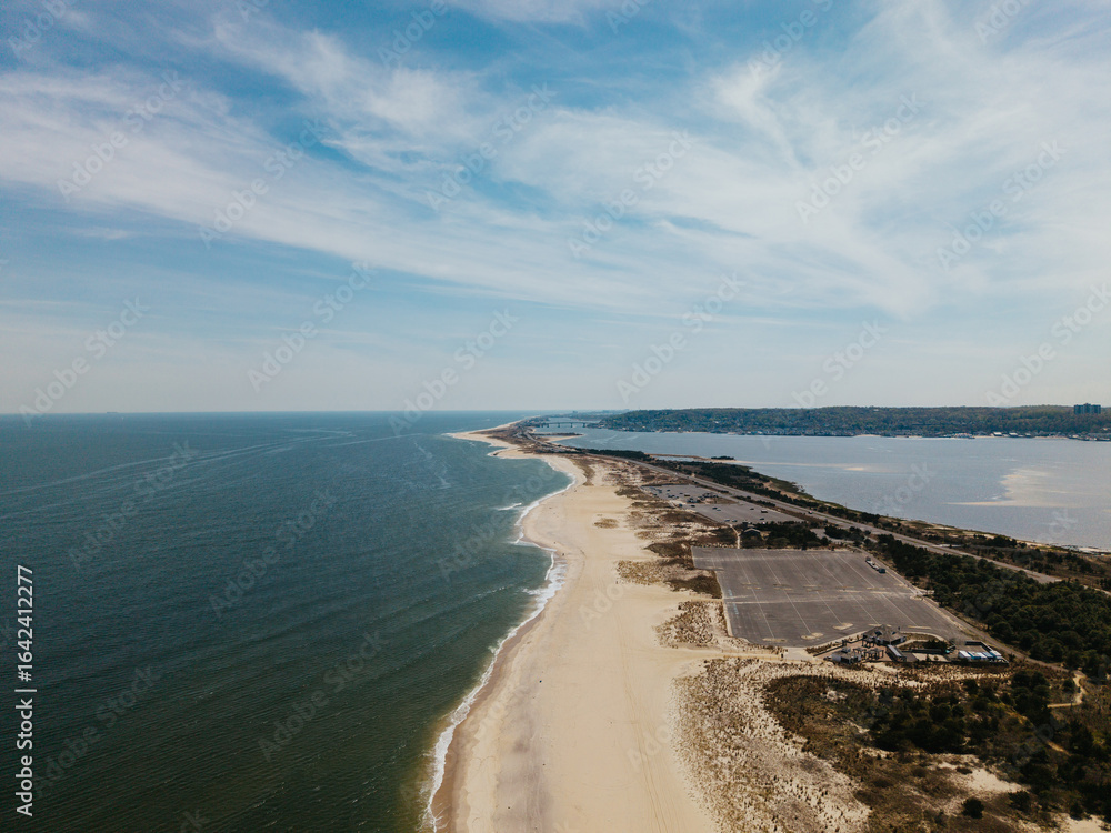Coastal View of a Sandy Beach and Tranquil Ocean Under Clear Skies Coastal View of a Sandy Beach and Tranquil Ocean Under Clear Skies
