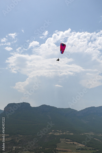 Man paragliding in the town of Organya in the province of Lleida in northern Spain in August 2025.