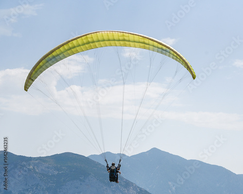Man paragliding in the town of Organya in the province of Lleida in northern Spain in August 2025.