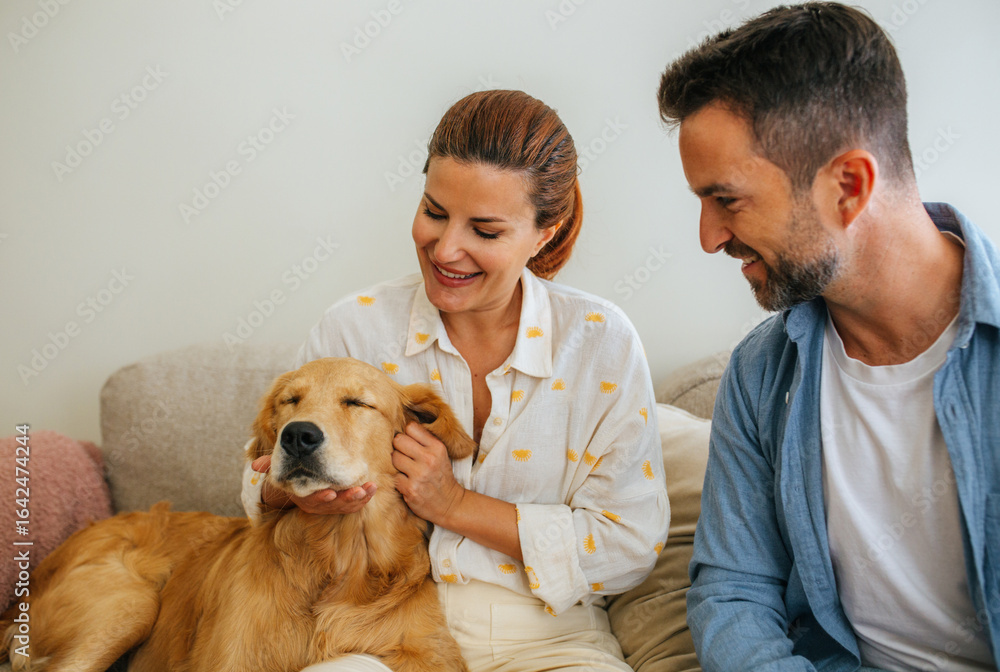 Couple petting dog