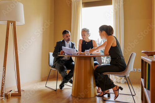 Wallpaper Mural Financial advisors discussing investment strategy together at office Torontodigital.ca