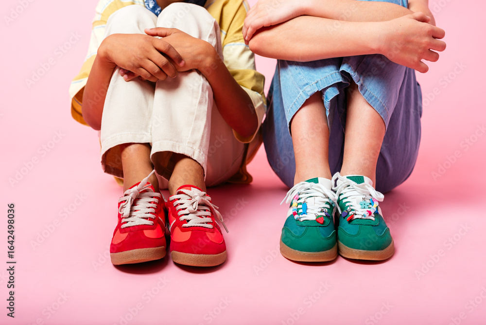 © Peninsula/Stocksy - Colorful Kids' Sneakers on Pink Background © Peninsula/Stocksy - Colorful Kids' Sneakers on Pink Background
